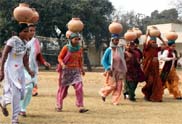 Participants of a matka race held during a women's sports meet at Nehru Stadium in Gurgaon