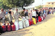 A long queue of consumers waiting for refills outside an LPG agency at Sampla