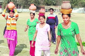 Women participate in a chatti race at the Rural Women Sports Competition organised by the Gramin Mahila and Bal Vikas Samiti at Karan Stadium in Karnal