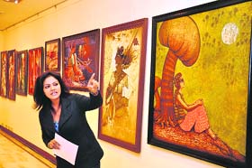 Art promoter-cum-curator Maandavi S Sharma explains a creation at an exhibition of paintings and sculptures in Gurgaon