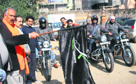 State president of the BJP Shamsher Singh Manhas flags off bikers of the Jammu Kashmir Royal Riders Association from Jammu to Uttrakhand on Thursday.