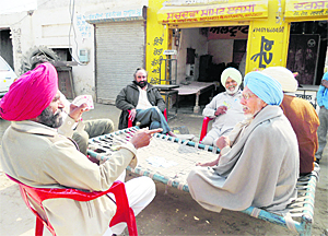 Badal village residents play cards and discuss politics.