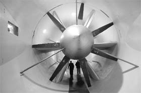 People walk through the blades of the Glenn L. Martin Wind Tunnels fan following testing of the aerodynamics of a concept car at the University of Maryland in College Park, Maryland
