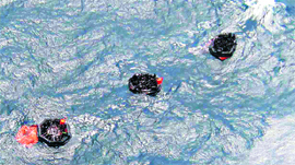 An aerial view of people in inflatable life rafts after the ferry in which they were travelling sank off the east coast of Papua New Guinea on Thursday.