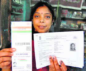 Rajni Dhawan shows her UID card with wrong information in Amritsar.