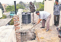 The enforcement staff with the estate office clear encroachments at a house in Sector 33 of Chandigarh on Friday