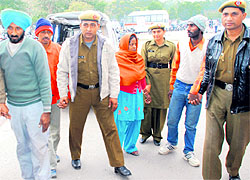 The Haryana police with the four accused at the Civil Hospital, Sector 6, Panchkula, on Friday