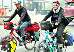 Braving the chill, two foreigners ride bicycles on the Delhi-Haridwar-Dehradun National Highway on Friday conveying a message to the people to use eco-friendly modes of transportation to protect the environment