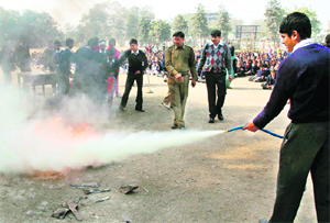 Fire officials display a mock drill at a government school in Gurgaon on Friday.