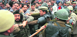 Members of the PDD Daily Wagers Union clash with the police during a protest in support of their demands in Jammu on Friday.