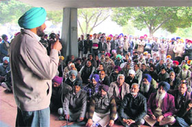 A union leader addresses a gate rally of the PAU Employees Union at Punjab Agricultural University on Friday in Ludhiana. 