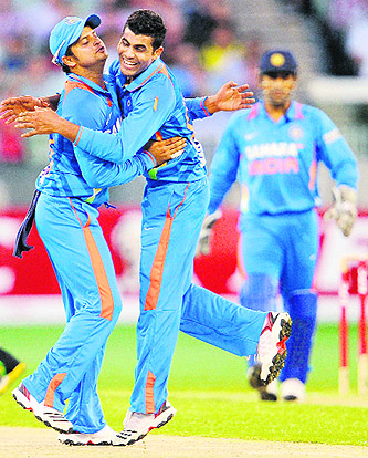Ravindra Jadeja (R) is congratulated by teammate Suresh Raina after dismissing Australian batsman David Hussey (unseen) in the their Twenty20 match at the MCG in Melbourne on Friday.  AFP