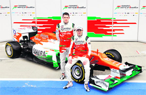 Sahara Force India Formula One drivers Paul di Resta (L) and Nico Hulkenberg unveil the new VJM05 racing car at the Silverstone circuit, England on Friday.