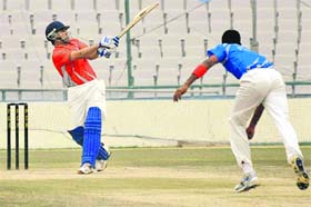 A player hits a shot during the Kings XI cricket match at PCA Stadium in Mohali on Saturday