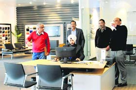 Excise officials at a Porsche showroom in Industrial Area, Phase I, Chandigarh, on Saturday