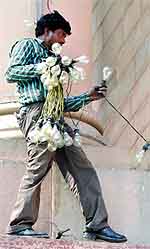 A labourer removes bulbs after the Republic Day celebrations in New Delhi on Saturday