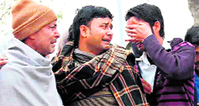 unconsolable relatives of three labourers who were swept away in the canal.