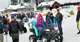 Tourists enjoy themselves at the Solang valley, 13 km from Manali, on Saturday.