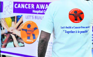 A staff member of Basavatarakam Indo-American Cancer Hospital and Research Institute participates in a cancer awareness walk in Hyderabad during World Cancer Day on Saturday. 