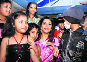 Bollywood actress Madhuri Dixit Nene interacts with cancer-affected children in Mumbai on Saturday.