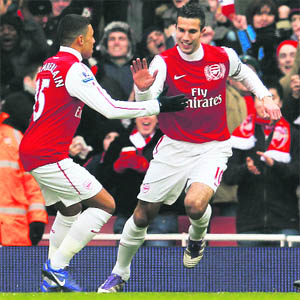 Arsenals Robin Van Persie (R) celebrates his goal against Blackburn Rovers with Alex Oxlade-Chamberlain during their English Premier League match in London on Saturday. Van Persie scored a hat-trick as Arsenal won 7-1. 