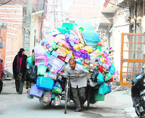 A street vendor pulls his overloaded rehri in Amritsar.