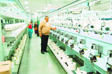 Kamal Dalmia shows an automatic machine in a processing unit in Amritsar