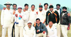 Players of CA Chandigarh XI strike a pose after winning the match. 