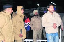 Police personnel conduct a raid at hostel number 5 of Panjab University in Chandigarh on Sunday.