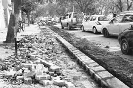 Work moves at a snails pace on widening of the commercial street passing through Mohali. 