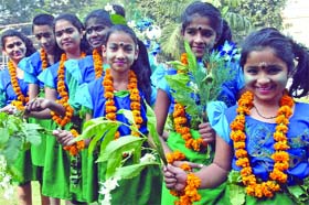Girls dress up in tribal attire for a festival at YMCA in New Delhi on Sunday