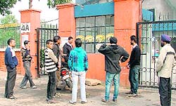 Disappointed sports lovers take a look at the kabaddi cup posters pasted at the entrance of Guru Nanak Stadium in Ludhiana.