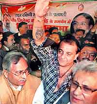 Actor Sanjay Dutt waves during a Congress poll rally in Allahabad