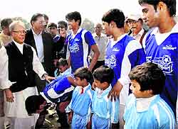 Union Finance Minister Pranab Mukherjee meets players during a final football match named after his father KK Mukherjee at Suti in Murshidabad on Sunday