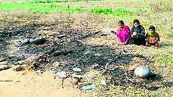 Shell-shocked girls at the site of their burnt hut at Herian village near Samrala