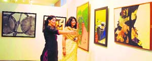 Vibrant Hues : Art Lovers enjoy work at the Exhibition