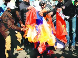 Protesters opposed to the Syrian regime burn Russian and Chinese flags in Beirut.