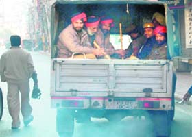 A vehicle ferrying policemen emits smoke leading to air pollution in Amritsar