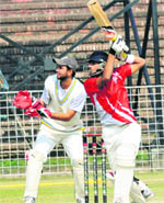 A batsman plays a cover drive as the wicketkeeper looks on during a match of the KXIP Cup at the Sector-16 stadium in Chandigarh