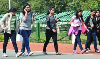 Youngsters take a stroll as the sun shines at the Rajpath in New Delhi on Monday. 
