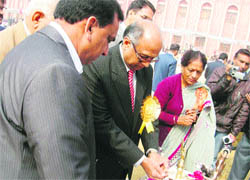 Haryana State Election Commissioner Dharam Vir lights up the traditional lamp to inaugurate a function at BPS, Bhiwani.