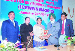 Prof SS Dhillon gives away the Young Scientist Award to a student during a conference on environment held at CDLU in Sirsa
