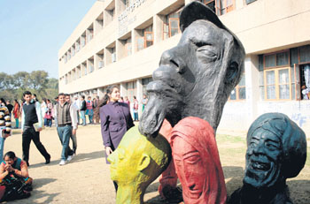 Visitors look at sculptures during a workshop at the University of Jammu on Monday. Tribune photo: Inderjeet Singh