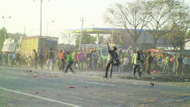 Workers pelt the police with stones near Hamira in Kapurthala on Monday.