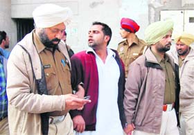 The police takes away a man who was involved in a clash at the District Courts Complex in Ludhiana on Monday