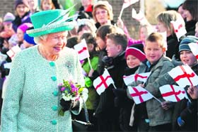Britains Queen Elizabeth II walks past well-wishers as she leaves following a visit to Dersingham Infant and Nursery School, Norfolk, on Monday