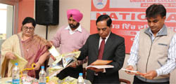 Dignitaries go through the pages after releasing a book on Swami Vivekananda at Abohar. 