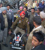 A police constable driving away the impounded motorcycle in a town market during the anti-encroachment drive launched by Fazilka police.
