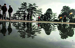 A view of The Ridge reflected in rainwater in Shimla