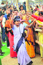 A BSP security wing member dances during Mayawatis election rally in Azamgarh